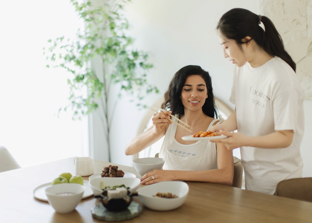 Doula providing professional postpartum care